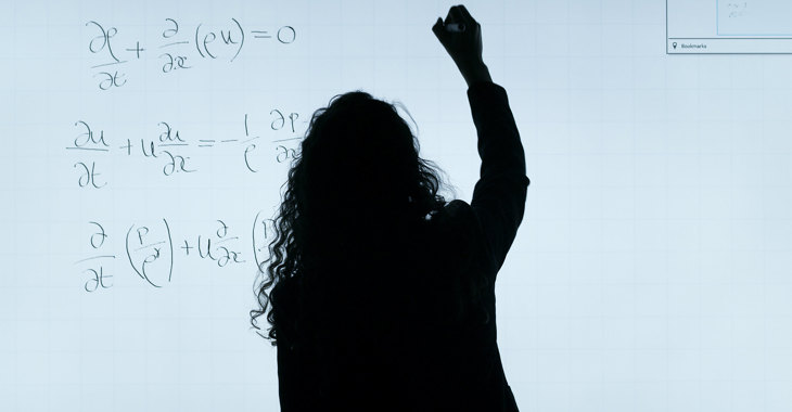 Female Aerospace Engineer Writes Equations