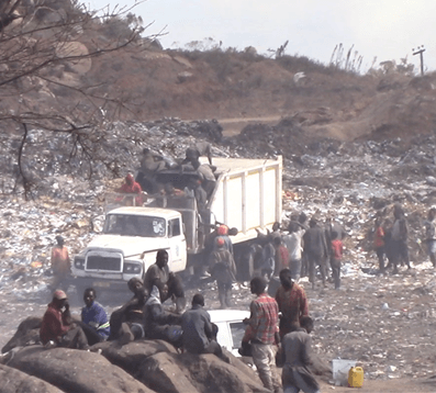 Residents storming a waste truck in Blantyre City dumpsite. Photo credit to William Bray