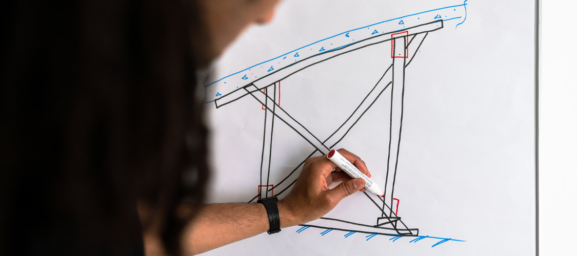 Structural engineer draws on whiteboard